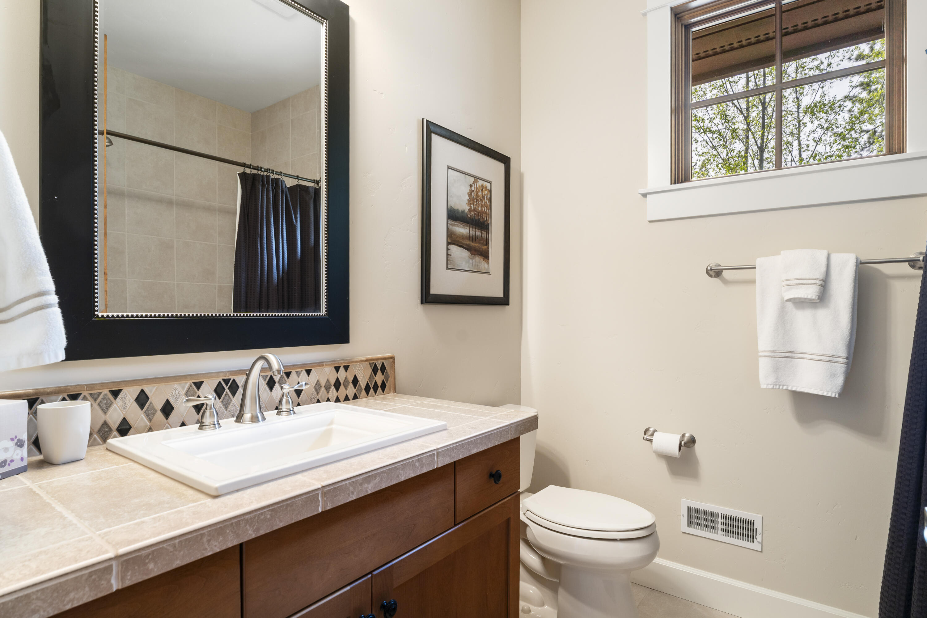 56155 Sable Rock Loop, Unit 277 Bend, OR 97707 - Photo 52 of 63 The attached full bath offers convenient access for guests and adds versatility to the upstairs bonus and entertainment area.