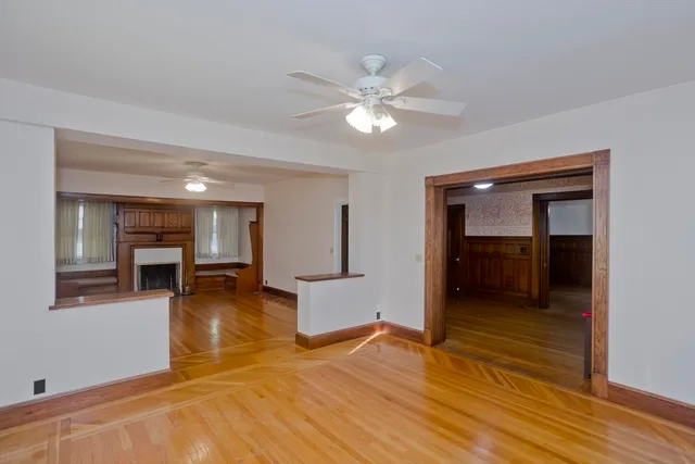a view of a livingroom with wooden floor and workspace