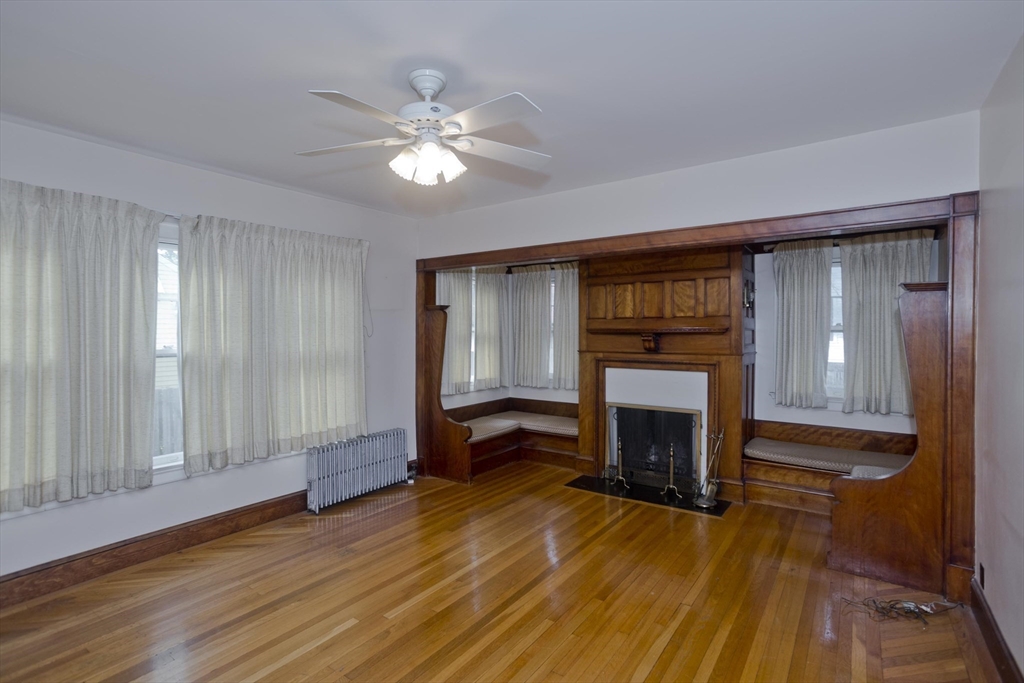 128 Maplewood Terrace Springfield, MA 01108 - Photo 17 of 40 a view of an empty room with wooden floor fireplace and a window