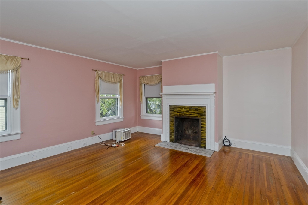 128 Maplewood Terrace Springfield, MA 01108 - Photo 26 of 40 a view of an empty room with wooden floor fireplace and a window