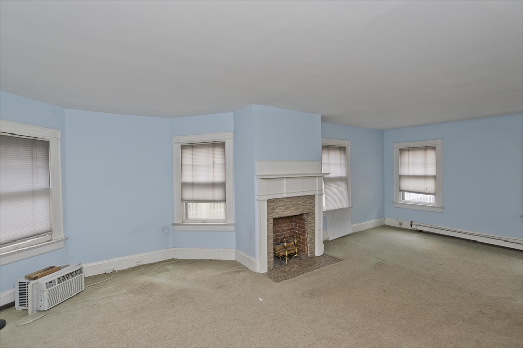 128 Maplewood Terrace Springfield, MA 01108 - Photo 29 of 40 an empty room with windows and fireplace