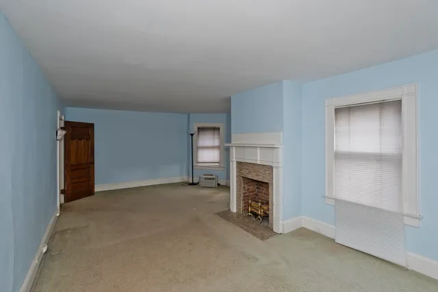an empty room with fireplace