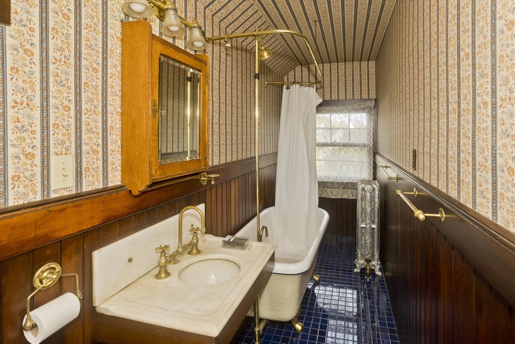 128 Maplewood Terrace Springfield, MA 01108 - Photo 34 of 40 a bathroom with a sink a toilet and a mirror