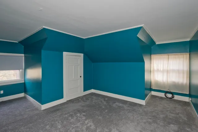 an empty room with windows and closet