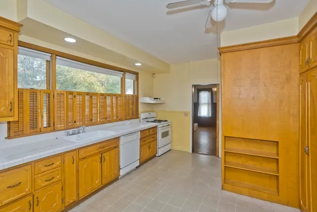 a kitchen with stainless steel appliances granite countertop a refrigerator and a stove