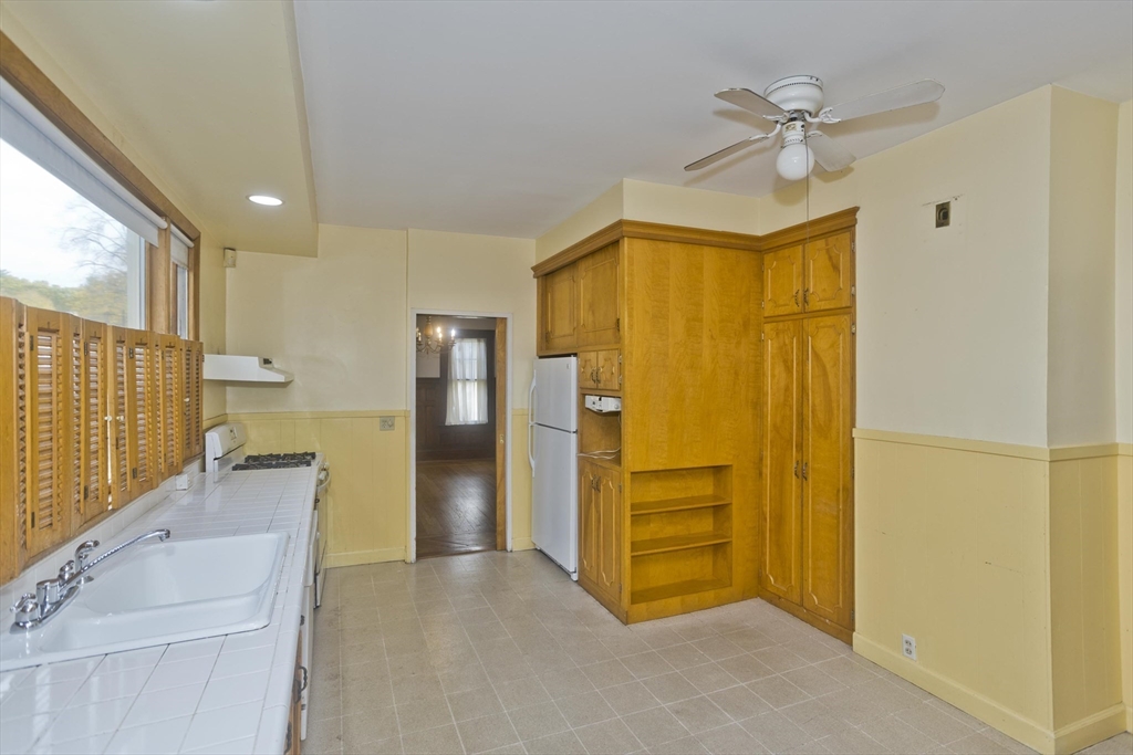 128 Maplewood Terrace Springfield, MA 01108 - Photo 8 of 40 a view of a kitchen with a refrigerator a sink and dishwasher
