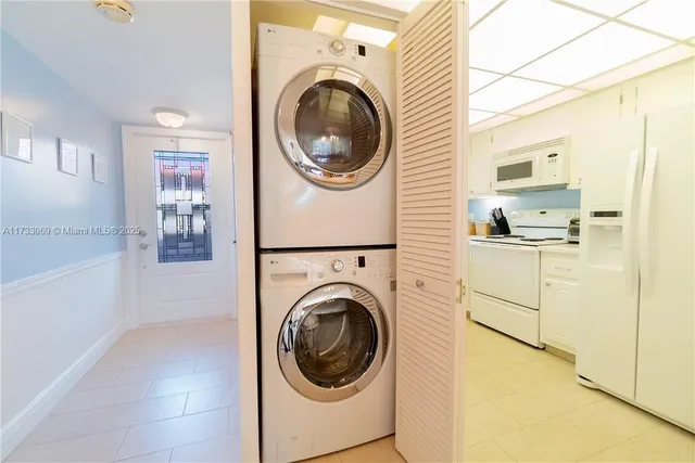 a utility room with sink dryer and washer