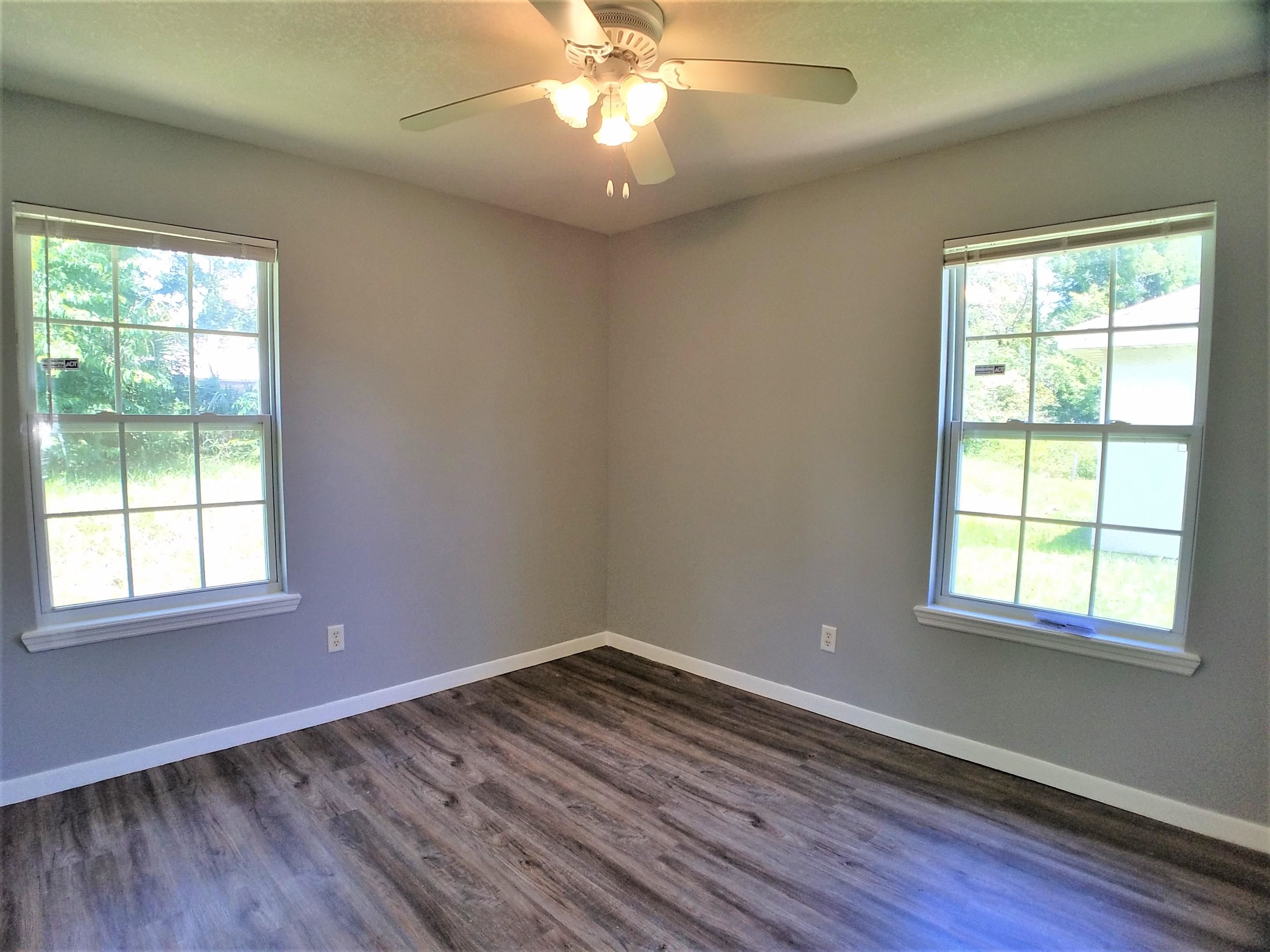 870 13th Street St. Augustine, FL 32084 - Photo 11 of 28 an empty room with wooden floor and windows
