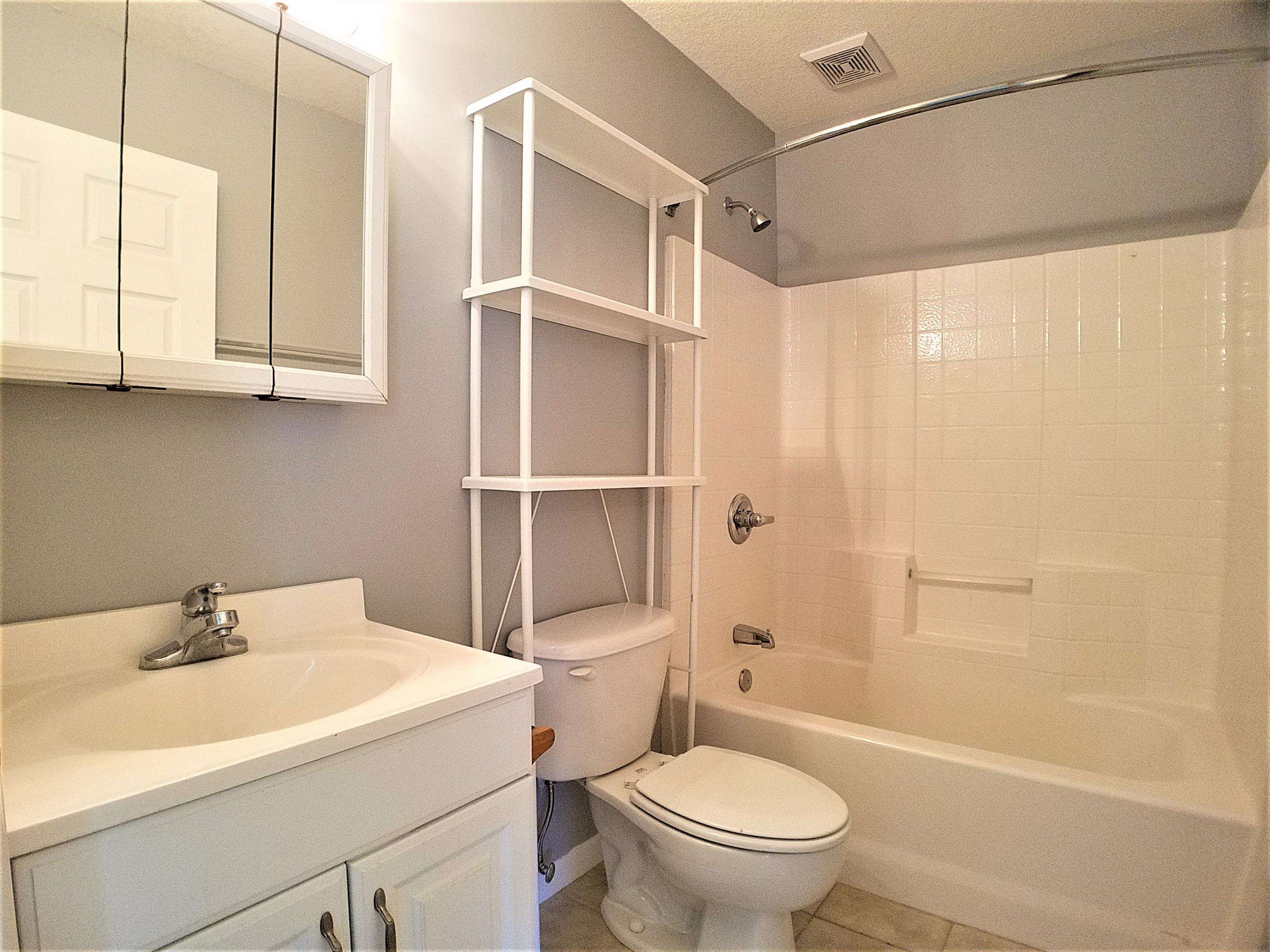 870 13th Street St. Augustine, FL 32084 - Photo 13 of 28 a bathroom with a sink a toilet and shower