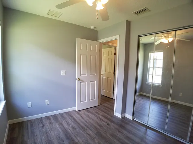 a view of a hallway with wooden floor