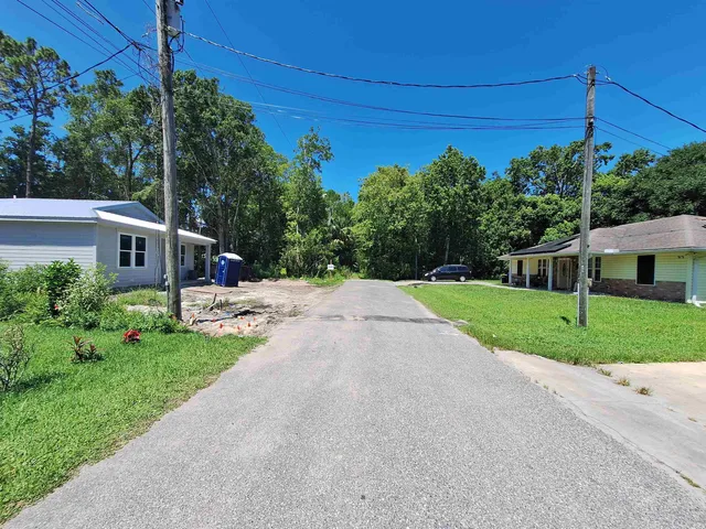 a house with green field in front of it