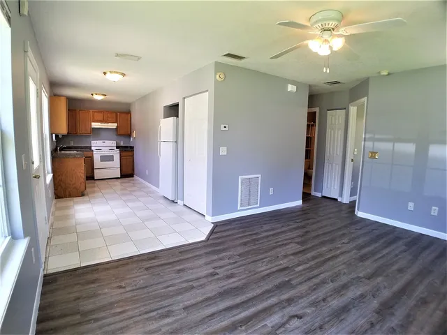 a view of a hallway with wooden floor