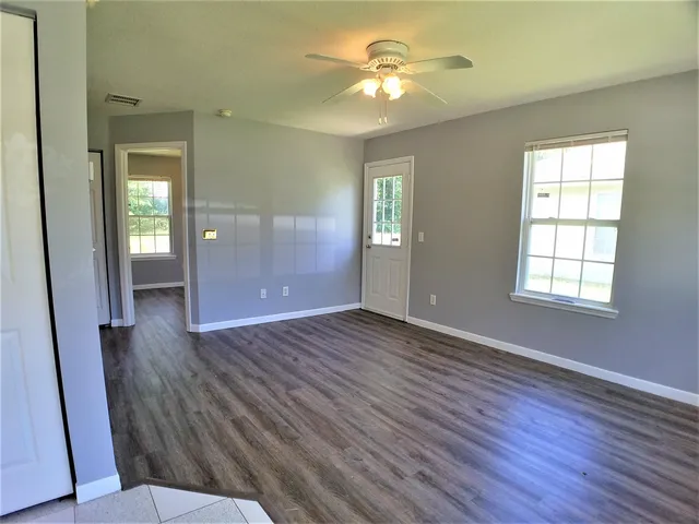 a kitchen with a stove sink and cabinets