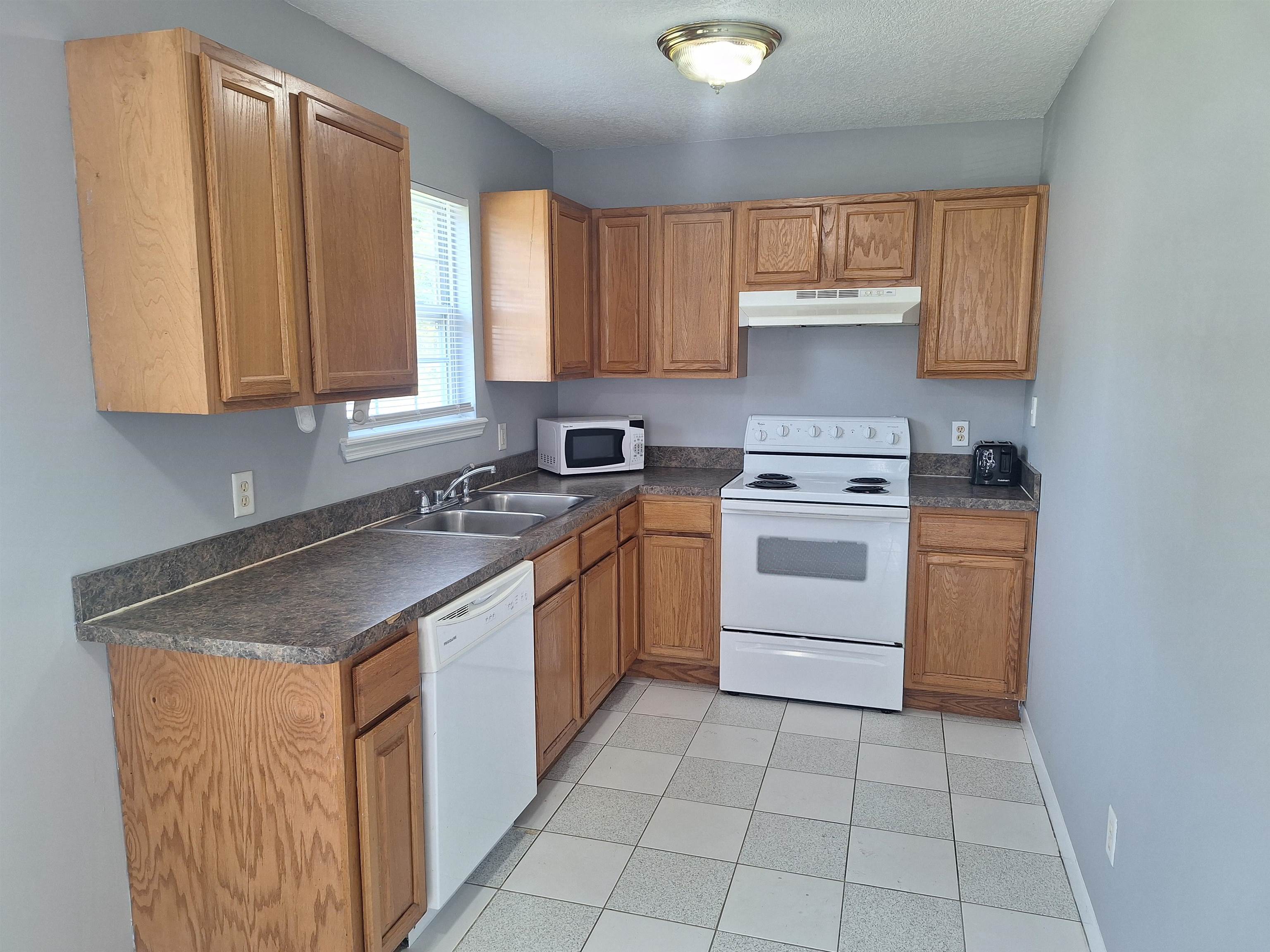 870 13th Street St. Augustine, FL 32084 - Photo 7 of 28 a kitchen with a stove sink and cabinets