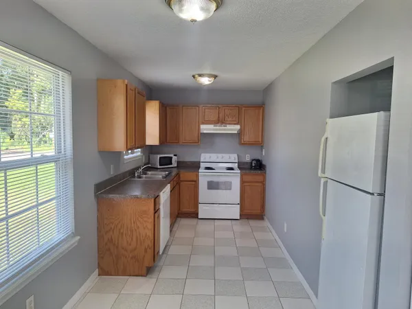 a view of a kitchen with furniture and windows