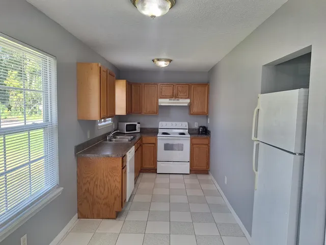 a view of a kitchen with furniture and windows