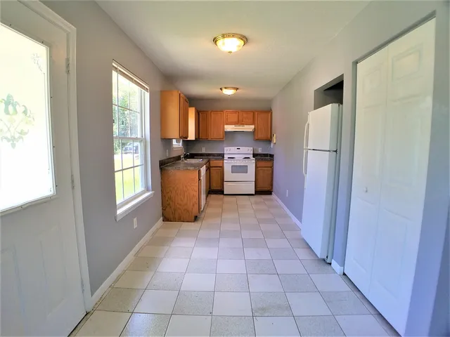 a view of a kitchen with an empty space and window