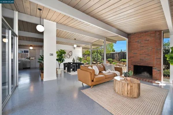 a living room with furniture and kitchen view