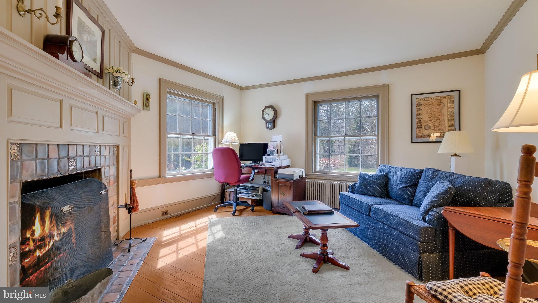 563 Pebble Hill Road Doylestown, PA 18901 - Photo 32 of 81 a living room with furniture a fireplace and a window