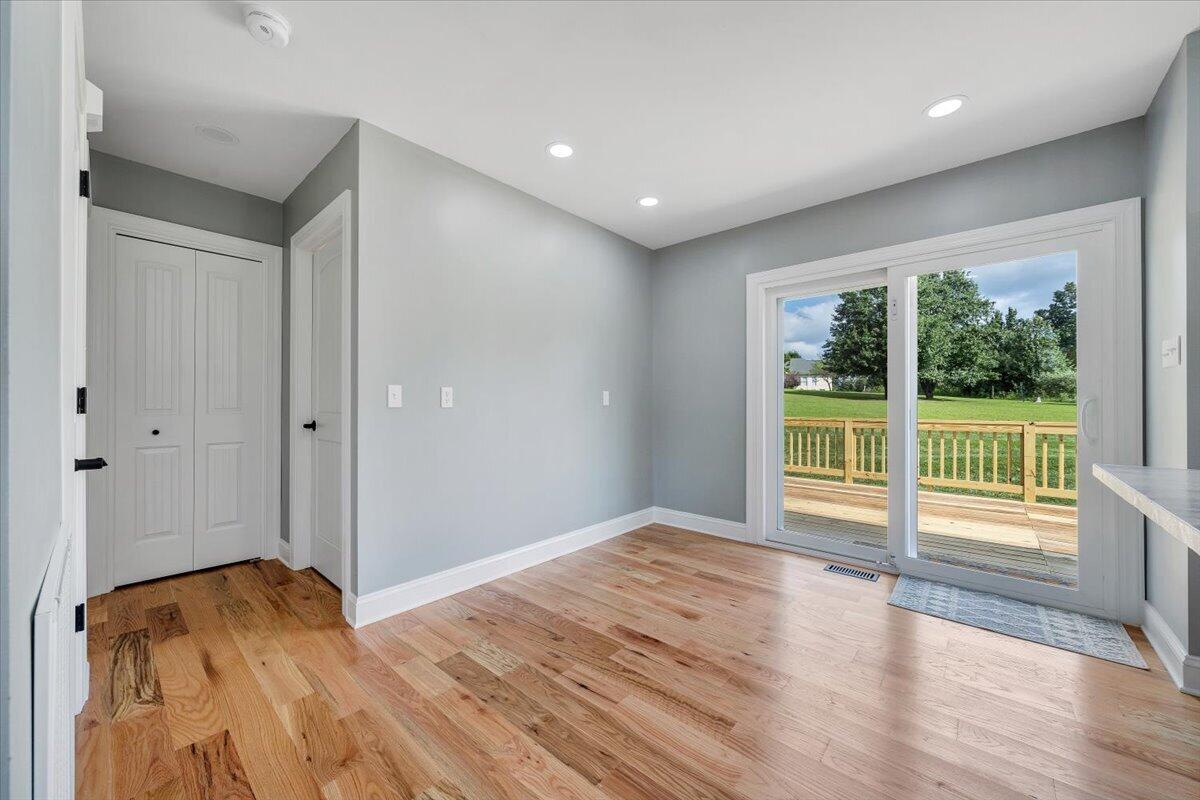 155 Mallard Cove Road Moneta, VA 24121 - Photo 12 of 51 a view of empty room with wooden floor and fan
