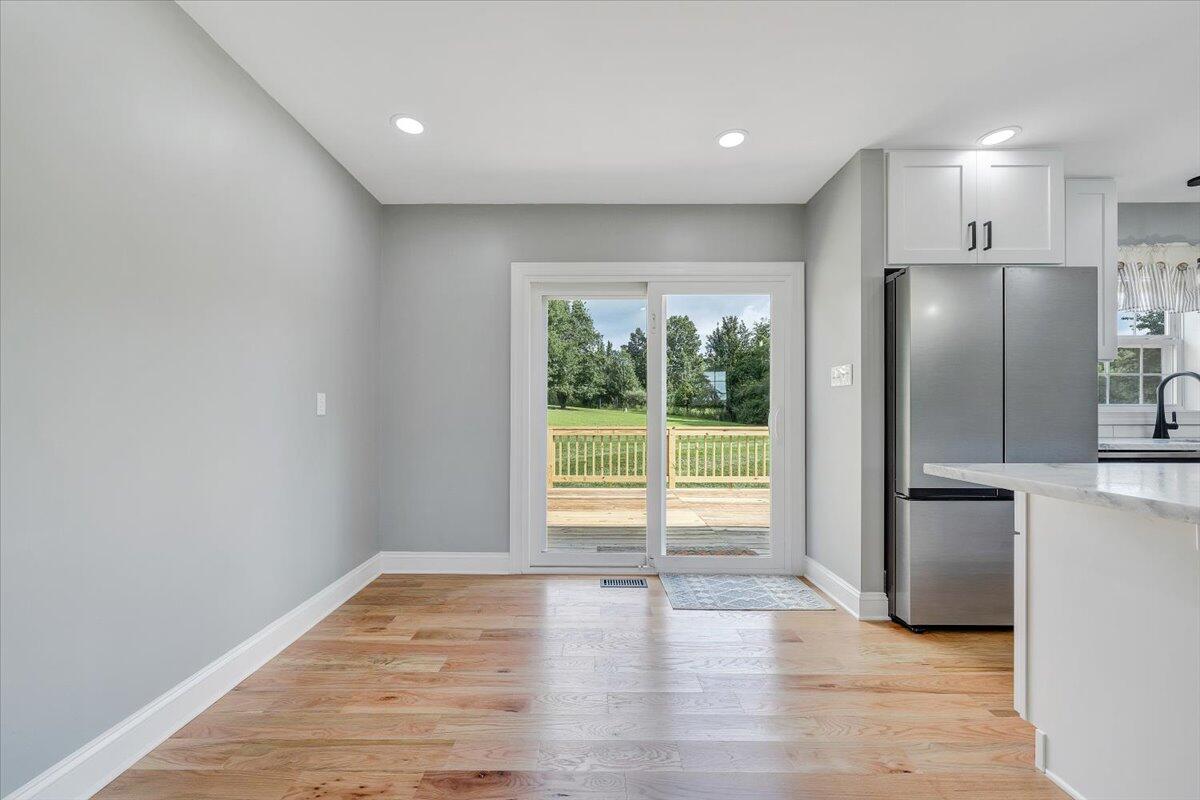 155 Mallard Cove Road Moneta, VA 24121 - Photo 13 of 51 a view of empty room with wooden floor and fan