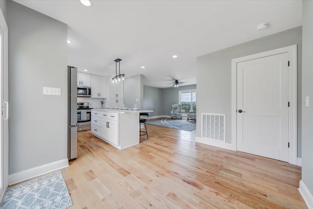 155 Mallard Cove Road Moneta, VA 24121 - Photo 14 of 51 a open kitchen with white cabinets and stainless steel appliances