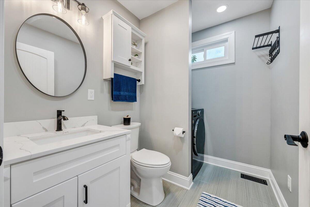 155 Mallard Cove Road Moneta, VA 24121 - Photo 15 of 51 a bathroom with a toilet a sink and mirror