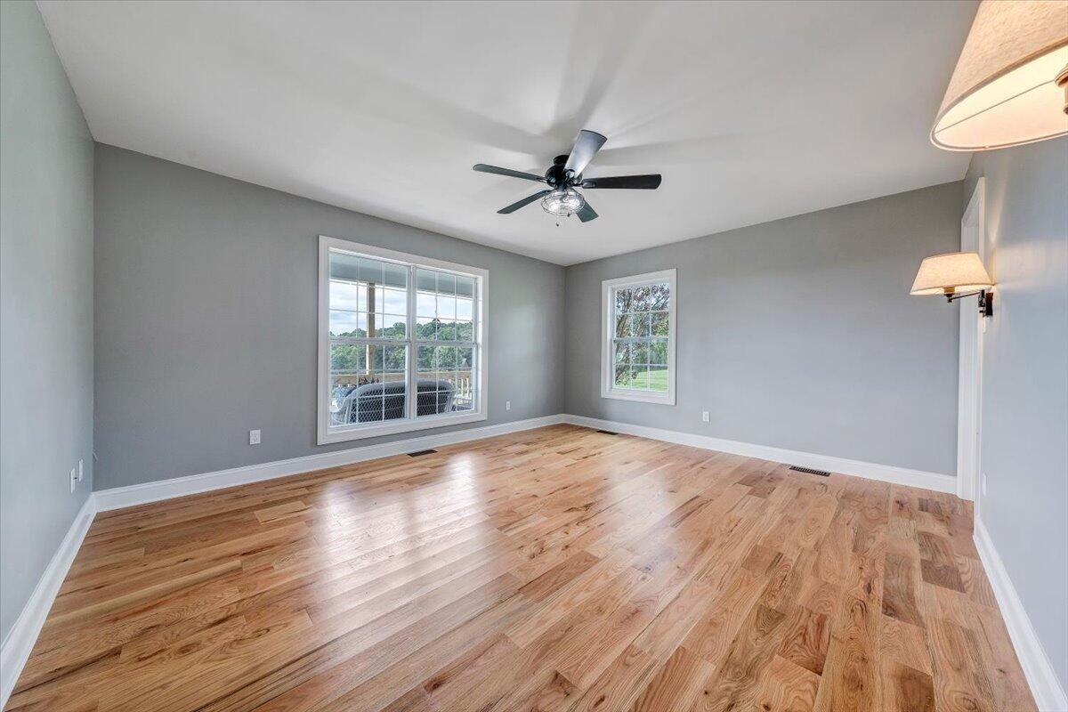 155 Mallard Cove Road Moneta, VA 24121 - Photo 16 of 51 a view of empty room with wooden floor and fan