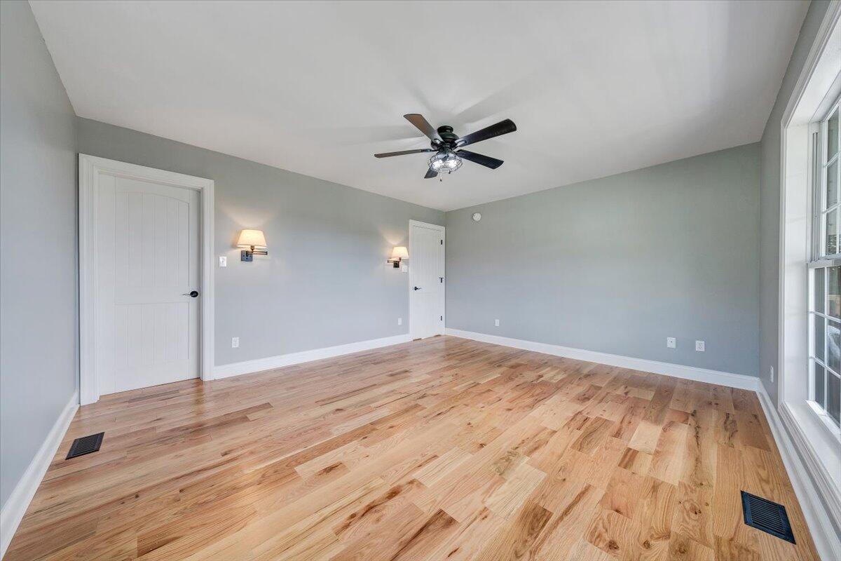 155 Mallard Cove Road Moneta, VA 24121 - Photo 17 of 51 an empty room with wooden floor and ceiling fan