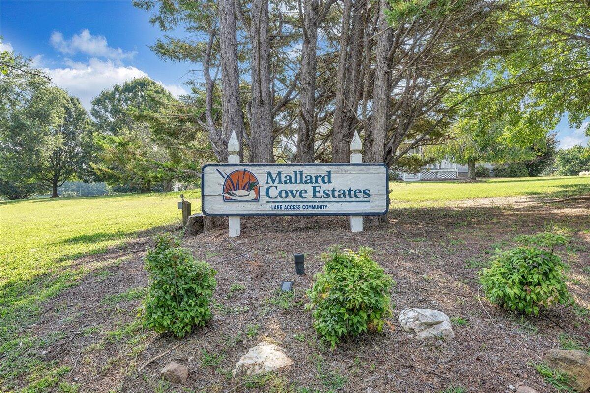 155 Mallard Cove Road Moneta, VA 24121 - Photo 49 of 51 a sign that is sitting in front of yellow house