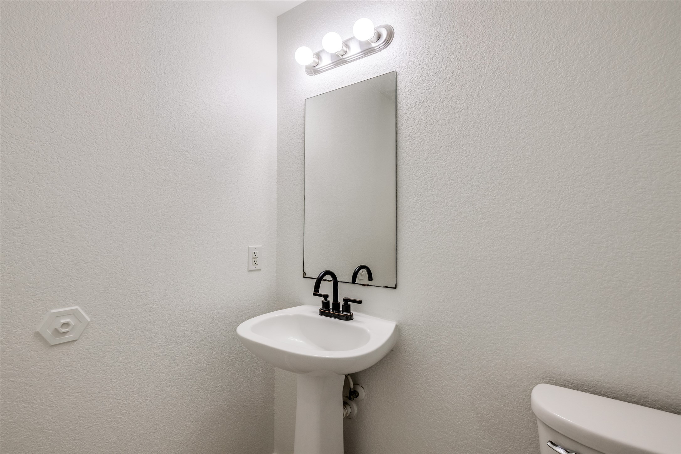 5750 Roehampton Court Houston, TX 77084 - Photo 13 of 25 a bathroom with a sink a mirror and toilet