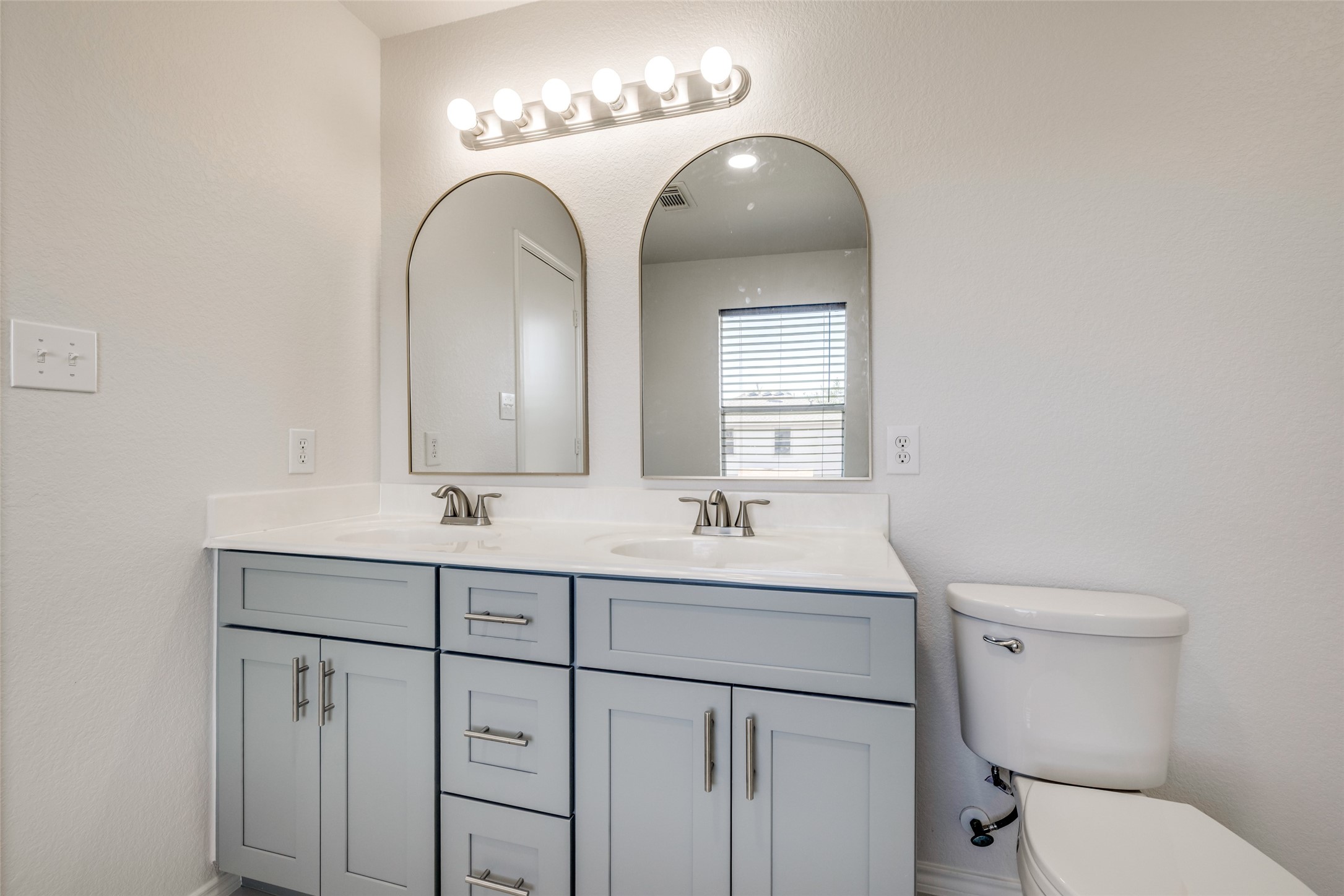 5750 Roehampton Court Houston, TX 77084 - Photo 18 of 25 a bathroom with a toilet sink and mirror