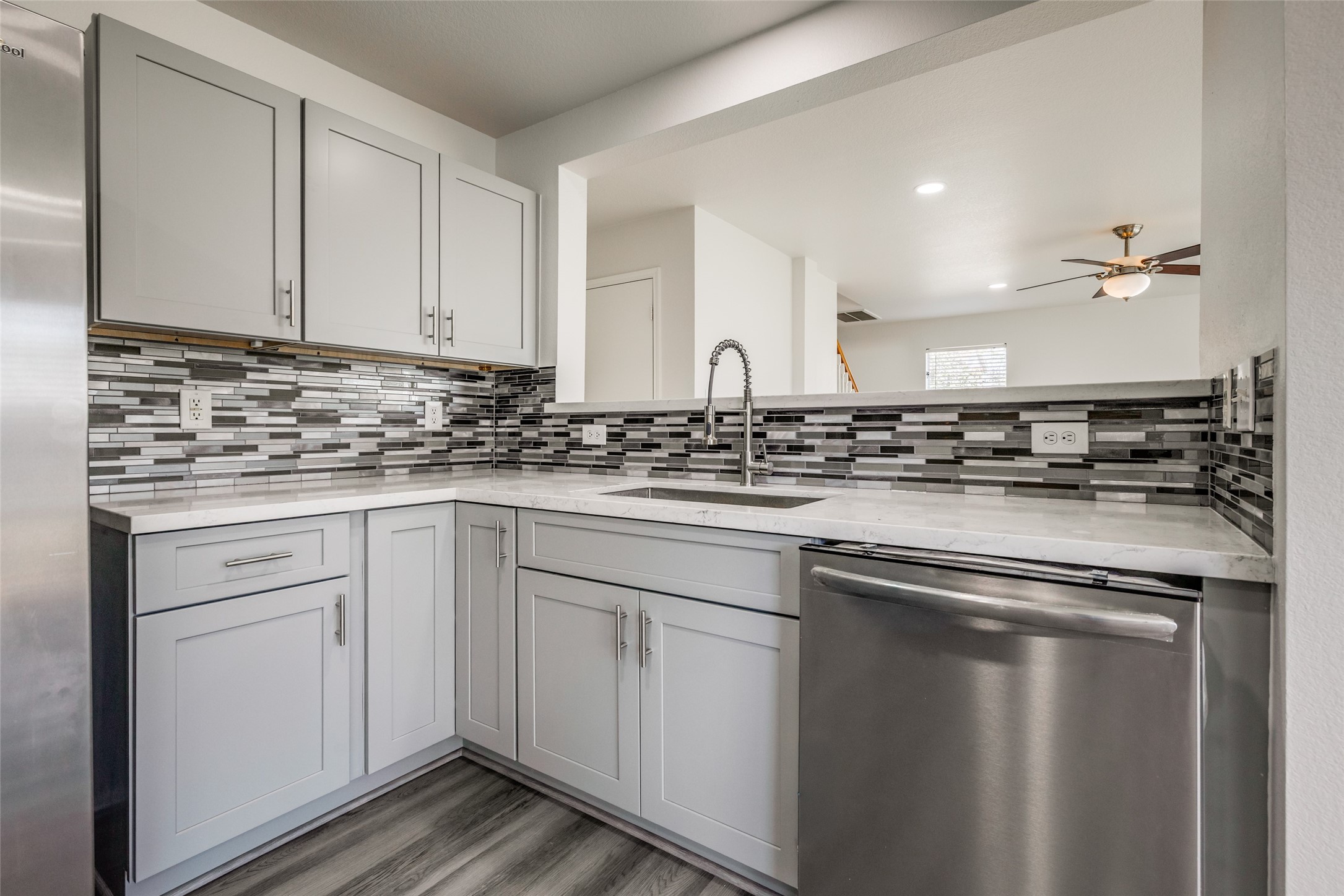 5750 Roehampton Court Houston, TX 77084 - Photo 3 of 25 a kitchen with white cabinets and white appliances