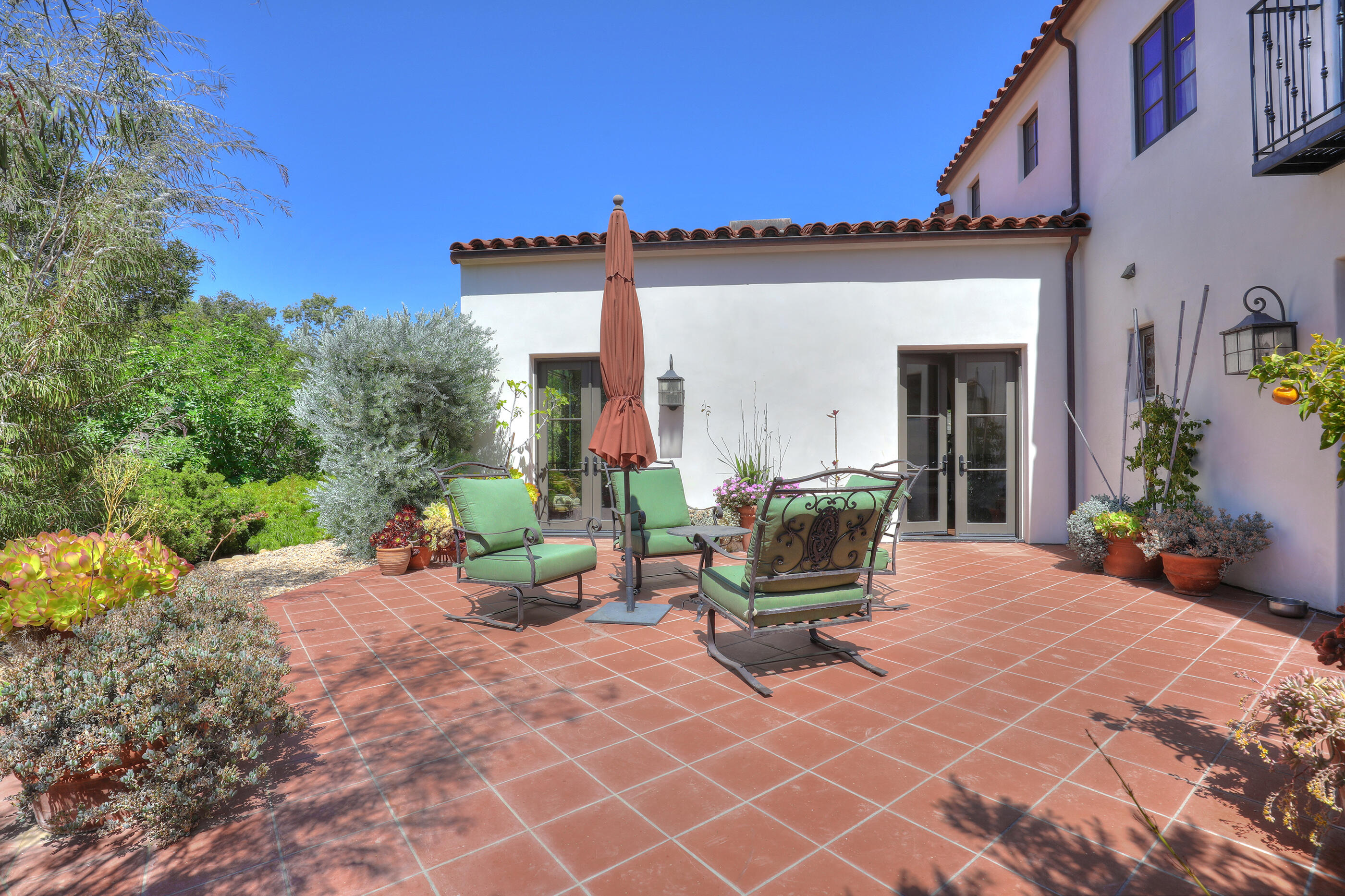 311 Ennisbrook Drive Montecito, CA 93108 - Photo 13 of 31 a view of a patio with table and chairs and potted plants