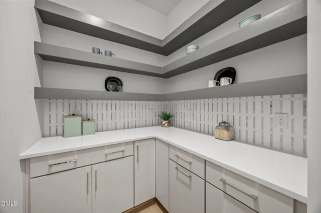 a living room with furniture potted plant and a flat screen tv