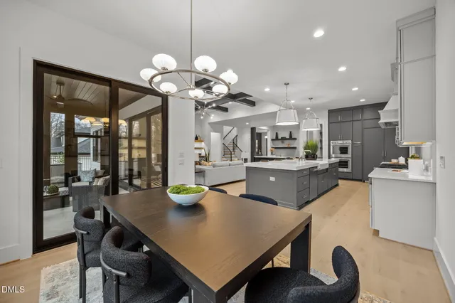 a bathroom with a granite countertop toilet a sink a mirror a bathtub and shower