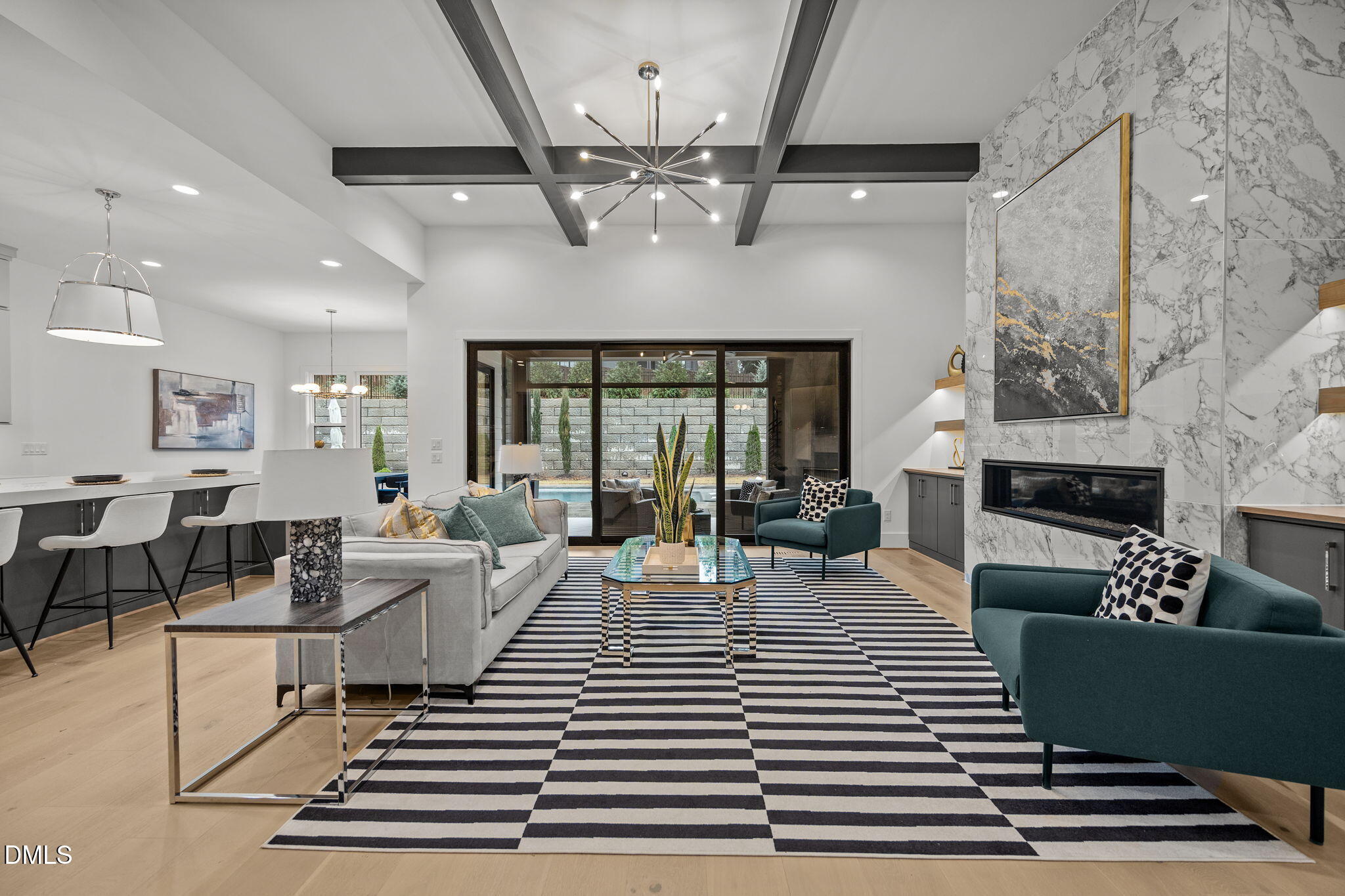 861 Wimbleton Drive Raleigh, NC 27609 - Photo 20 of 62 a living room with furniture a chandelier and a fireplace
