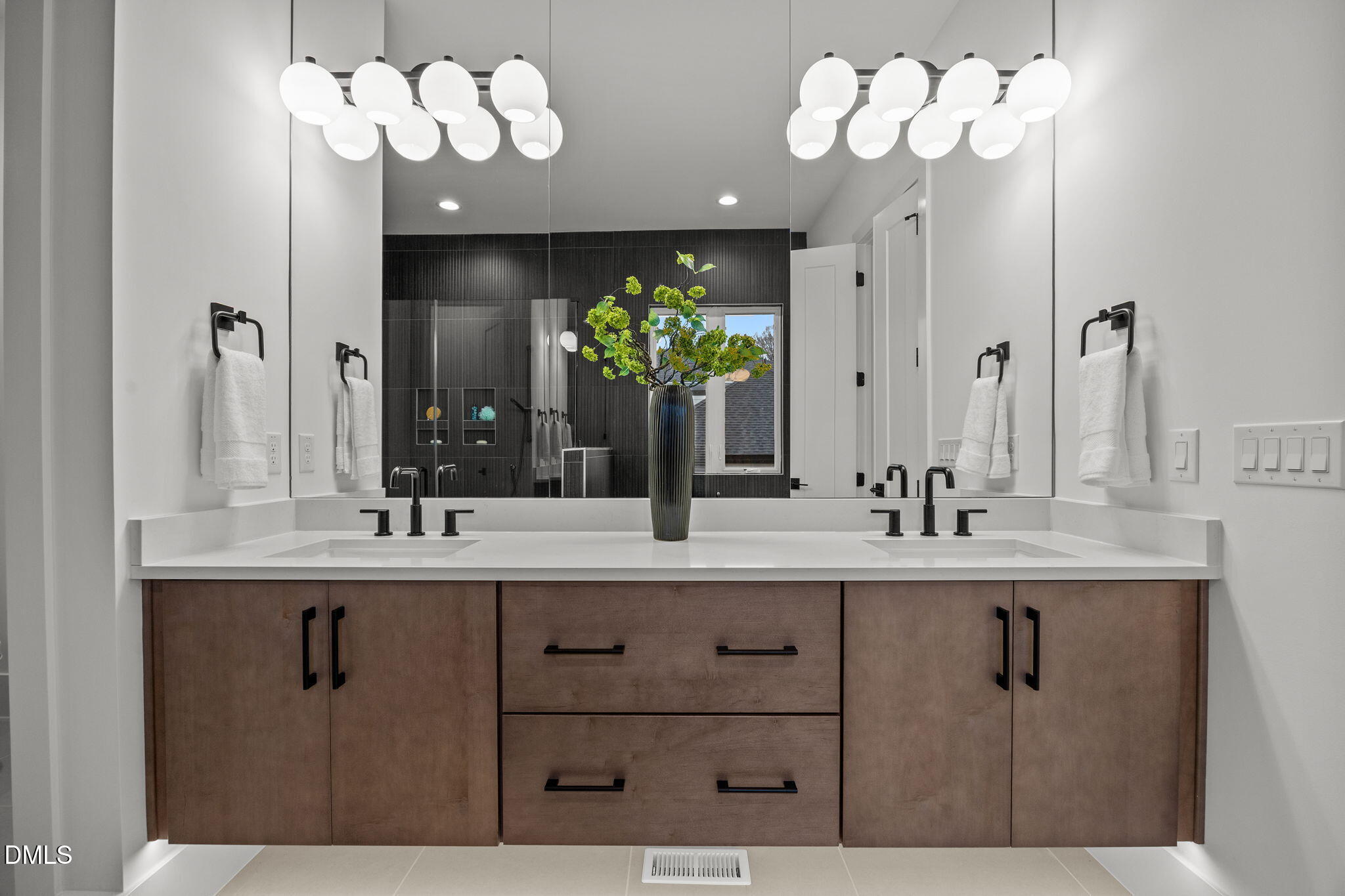 861 Wimbleton Drive Raleigh, NC 27609 - Photo 26 of 64 a bathroom with a sink chandelier and a mirror