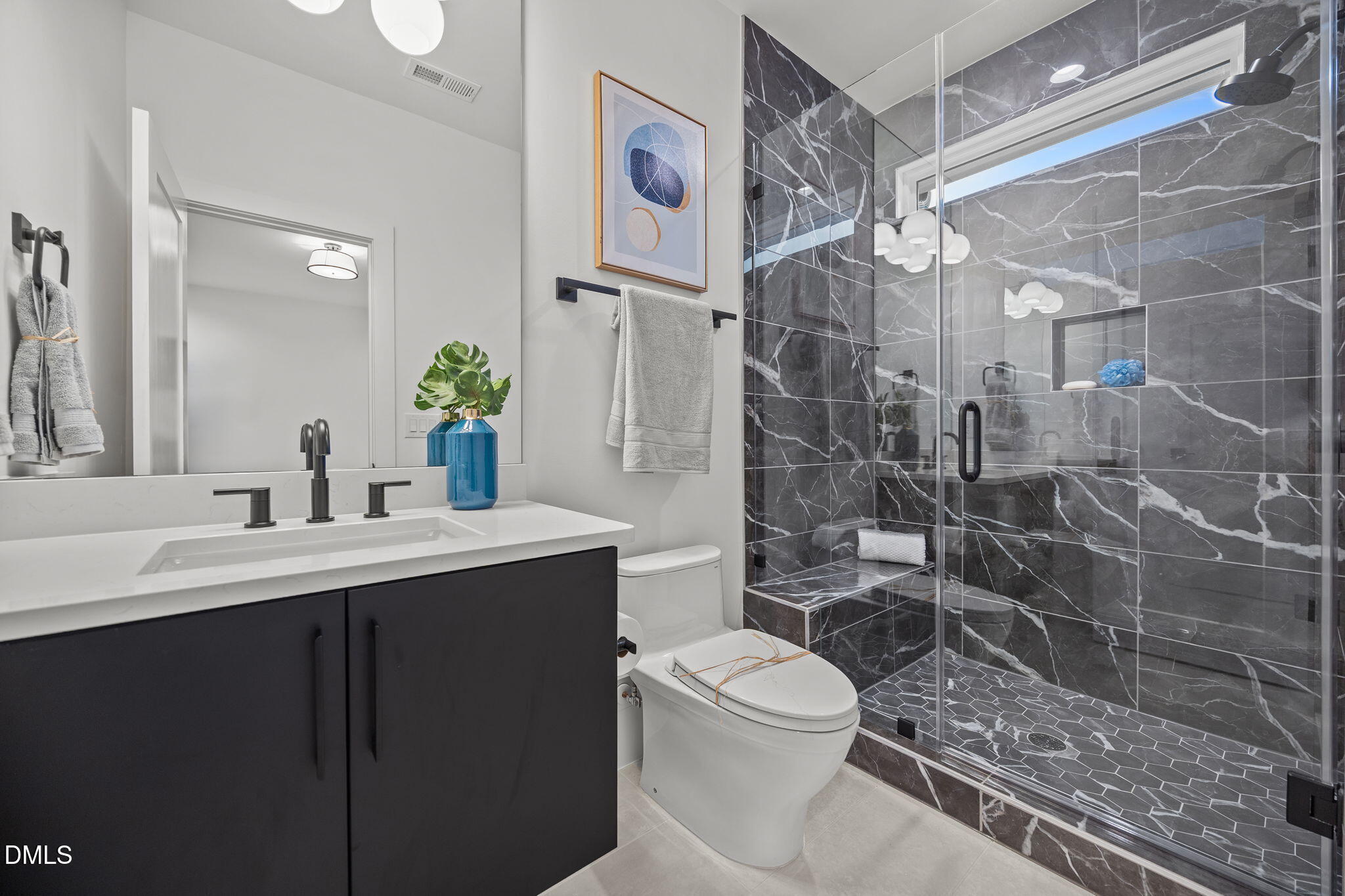 861 Wimbleton Drive Raleigh, NC 27609 - Photo 39 of 64 a bathroom with a sink a toilet and shower