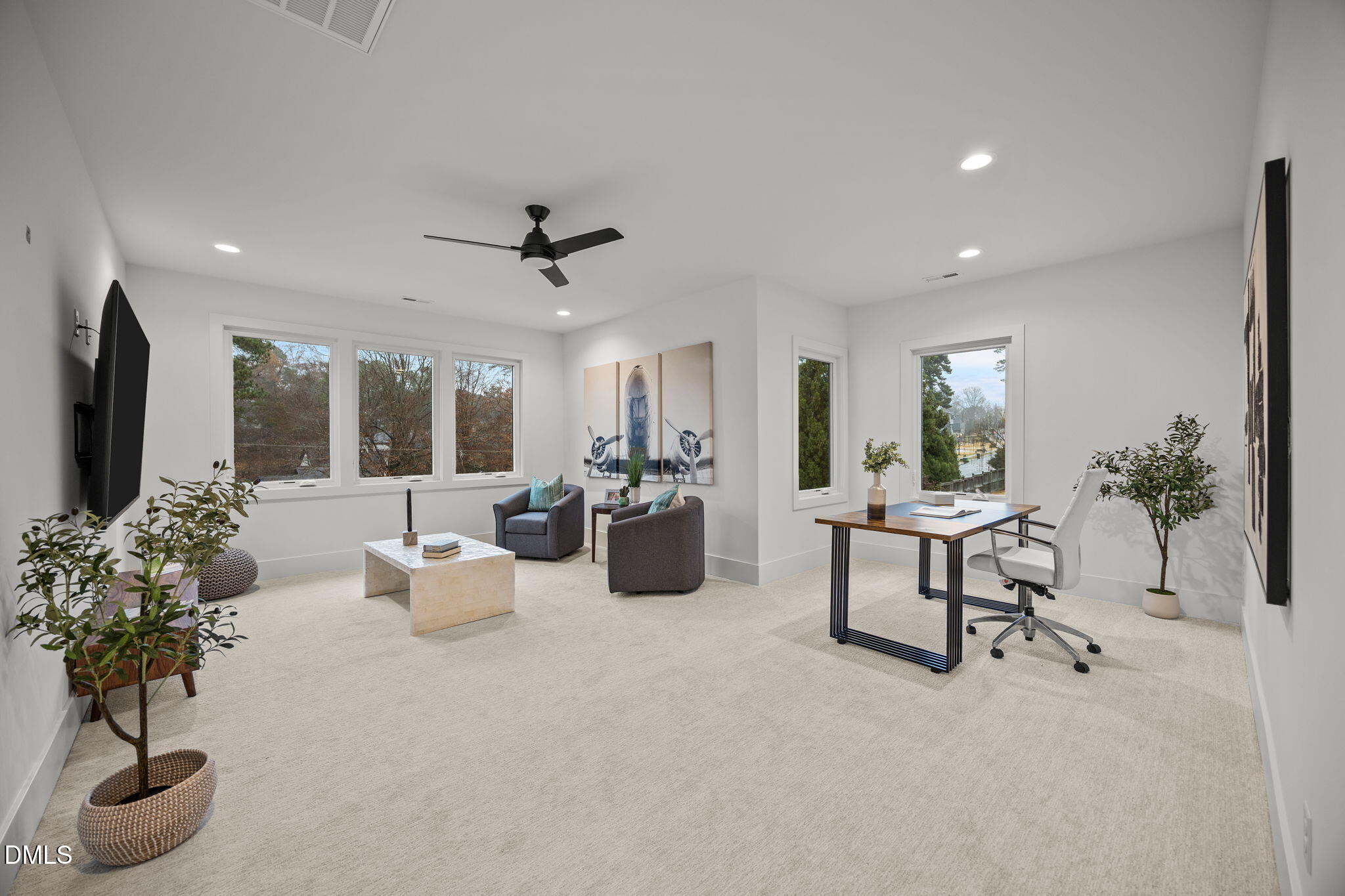861 Wimbleton Drive Raleigh, NC 27609 - Photo 42 of 62 a living room with furniture potted plant and a flat screen tv