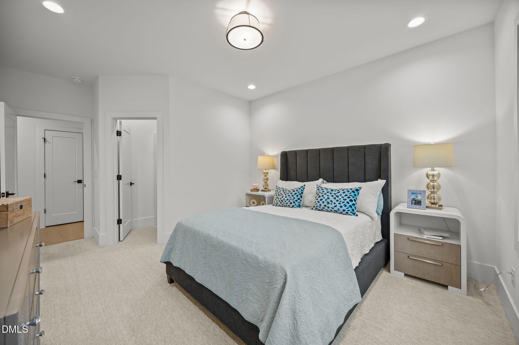 861 Wimbleton Drive Raleigh, NC 27609 - Photo 48 of 62 a spacious bedroom with a bed and a chandelier