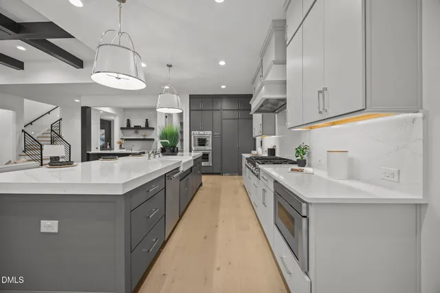 a living room with furniture a chandelier and a fireplace