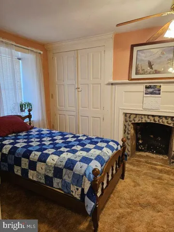 a bedroom with a bed and a fireplace