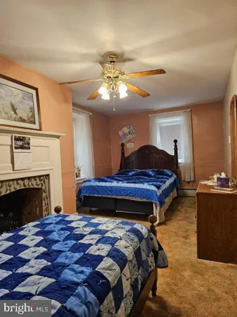 a bedroom with a bed and a fireplace