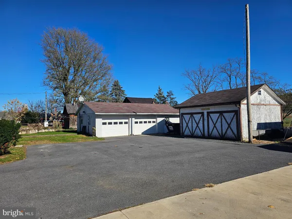 a view of house with outdoor space and parking