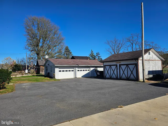 a view of house with outdoor space and parking
