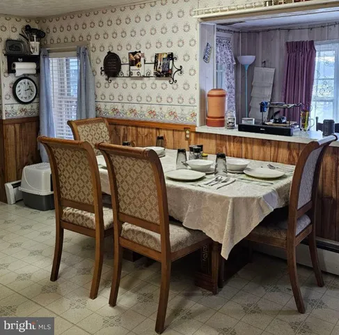 a view of a dining room with furniture and window