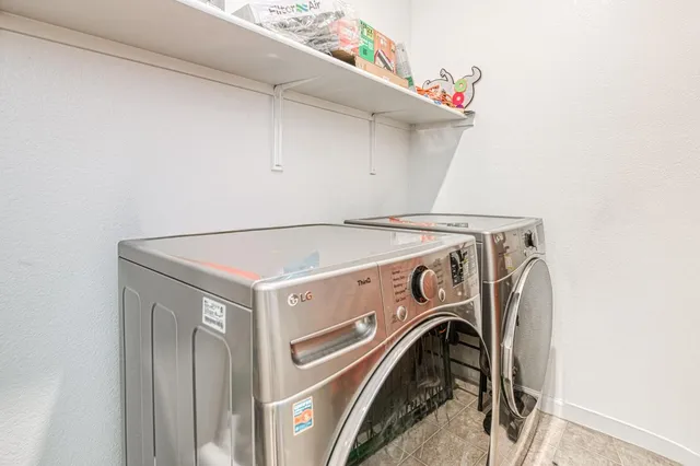 a living room with furniture a two couches and kitchen view