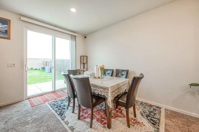 a kitchen with stainless steel appliances kitchen island granite countertop a sink and a refrigerator