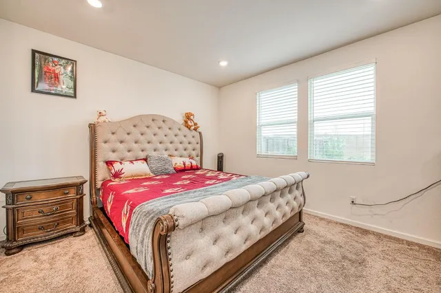 a bedroom with a bed and a dresser